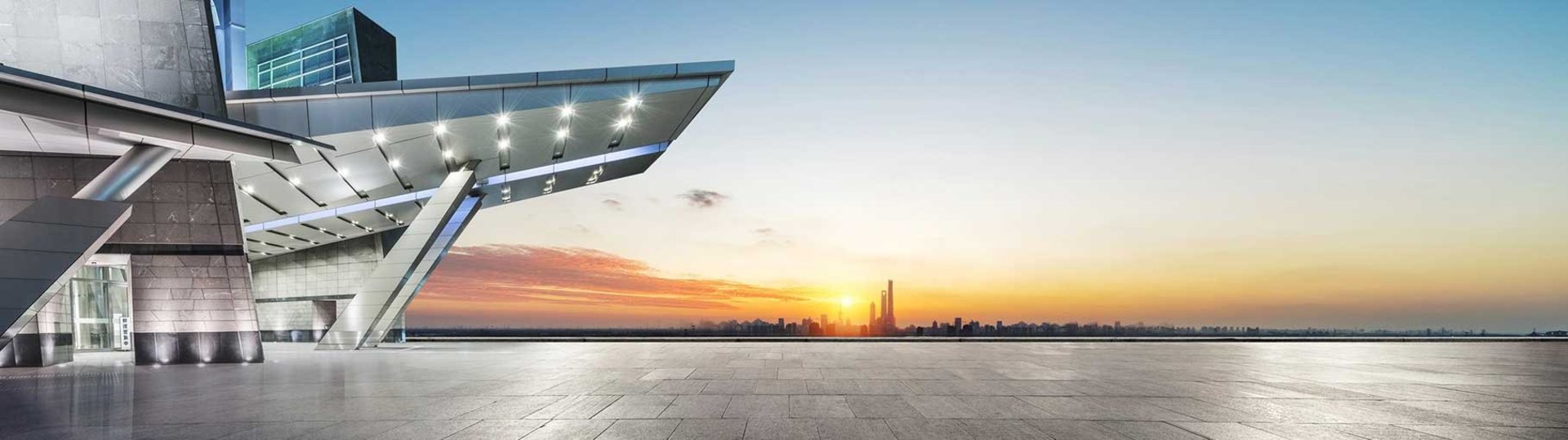 Modern architecture with futuristic building and skyline at sunset with a blue sky