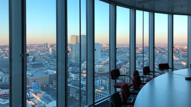 Modern conference room with large glass windows and panoramic views over the city.