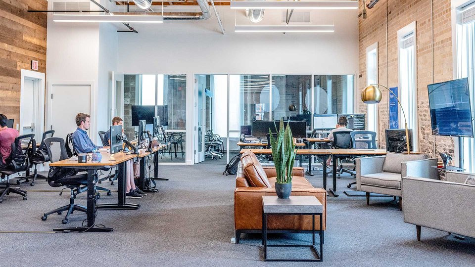 Open office with modern workstations, glass walls and stylish furnishings.