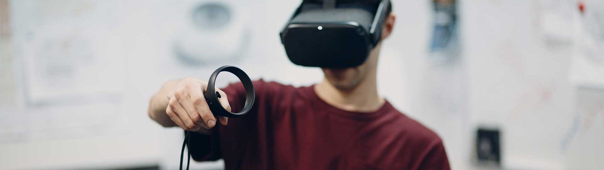 abat employee uses virtual reality goggles with abat logo and controllers.