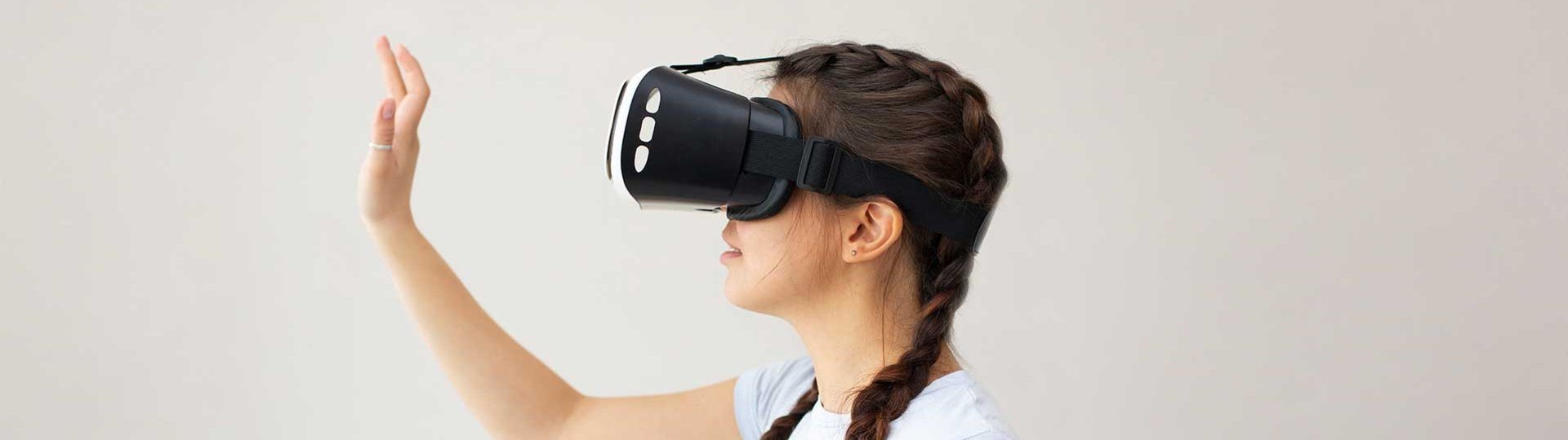 A Woman with virtual reality glasses gestures in a virtual environment.